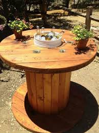 Electric Spool Repurposed Into Table With Ice Bucket Center For Drinks Wooden Spool Tables Spool Furniture Diy Outdoor Bar