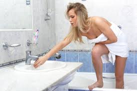 Undressing Young Woman With Towel In Bathroom Stock Photo, Picture and  Royalty Free Image. Image 15959453.