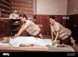 Woman Relaxing During Her Four Hand Massage Session Stock Photo Alamy