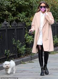 Tight jeans and ankle high heels give this a perfect rainy fall day ensemble, the thigh length coat overlays an all black outfit, complete with black rain boots. Olivia Palermo Looks Chic In A Camel Coat And Leather Thigh High Boots Readsector