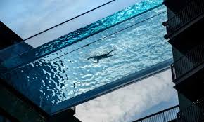 Washers wash the windows of modern skyscraper. London Sky Pool Among Wave Of Ever More Implausible Designs Swimming The Guardian
