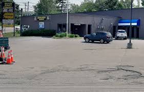 Black muscle car, black dodge challenger near neon gas gas station. Protester Claims Augusta Police Directed Vehicles Into A Private Lot Had Them Towed Centralmaine Com