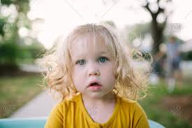 My post says blue hair and blonde eyes its a joke im v scared people are starting to dislike me or am i paranoid. Portrait Of A Toddler Girl With Curly Blond Hair And Blue Eyes Stock Photo Offset