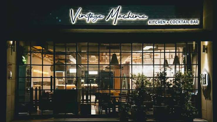 The chic industrial storefront of The Vintage Machine, AI generated