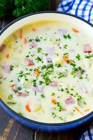 A Pot Of Ham And Potato Soup With Vegetables In A Creamy Broth Topped With Parsley Ham And Potato Soup Potato Soup Soup Dinner