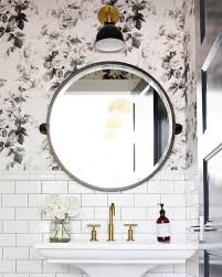 Black And White Tile Powder Room Small Powder Room With Floral Wallpaper Subway Tile And A Round Mirror Round Mirror Bathroom Powder Room Small Beautiful Bathrooms