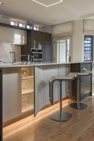 Soft Strip Shines Along The Bottom Of These Kitchen Cabinets For A Serene Effect Minimalist Lighting Led Lighting Solutions Kitchen And Dining Room Lighting