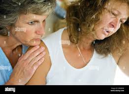 ADVANCE FOR WEEKEND OF JULY 7-8 ** Hospice nurse Joni Connelly leans in to  support Nancy Warner as the two watch Dick Warner finally resting after he  received 2,000 milligrams of