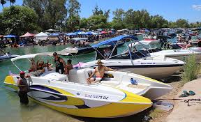Hundreds of boats gather and tie up in rows while people listen to music and bake in the late spring sun. Riverscene Magazine