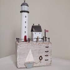 The entire arrangement sits on a simple silver tray, letting the pumpkin and flowers stand out. Little Keepers Cottage Harbour Handmade Lighthouse Ladder Sea Seaside Sailboat Shabbydaisies Flag House Ornaments Little Cottages Driftwood Art