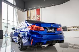 Driver's hands are on the steering wheel; M5 F90 Ipe Innotech Performance Exhaust