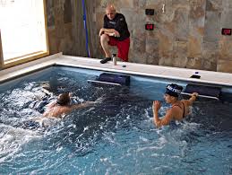 This Dual Propulsion Endless Pool Allows Room For A Pair Of Swimmers To Train At Once As A Coach Looks On Endless Pool Pool Workout Aquatic Exercises