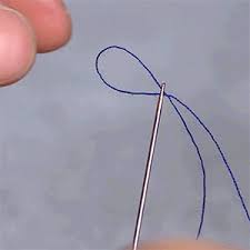 The hack involves rubbing the needle back and forth on the thread until a loop is formed. Blossom
