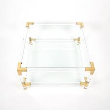 Located in national city, ca. Maison Jansen Paris Lucite And Brass Coffee Table