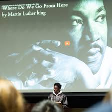 During School Meeting, community leaders from Blair's Inclusivity Committee  and Belonging & Equity Committee took to the stage to honor the life and  ongoing legacy of Dr. Martin Luther King Jr.