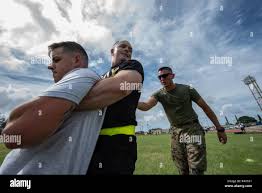 U.S. Army Spc. Tanner Moran, carries U.S. Air Force Staff Sgt. Colin Casey,  both Okinawa Joint Experience Green Team students, during the Okinawa Joint  Fitness Challenge Sept. 26, 2018, at Kadena Air