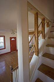 Exposed Studs Create An Open Stair Detail Cheap Basement Ideas Basement Remodeling Staircase Remodel