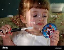 Apr 06, 2006; International Falls, MN, USA; Five-year-old Hope Moss looks  into a little mirror as she brushes her teeth to get ready for  kindergarten. Five-year-old Hope Moss suffers from brittle bone