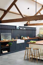 This modern kitchen features a gray and white color scheme, with a marble waterfall edge kitchen island, marble backsplash and stainless steel appliances. The Full Wall Of Tongue And Groove Pannelling Adds Lots Of Character To The Massive Kitchen It Also Has Interior Design Kitchen Devol Kitchens Kitchen Remodel