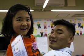 U.S. Marine Corps 1st Lt. Ryan Sim congratulates a