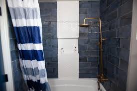 Tiled shower with gray, charcoal and blue mosaic accent. Modern Blue Bathroom With Blue Tile Shower Hgtv