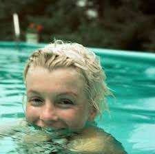 Marilyn Monroe swimming bare faced and smiling