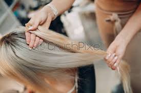 How to find hair salons near me? Hairdresser Female Making Hair Extensions To Young Woman With Blonde Stock Photo Crushpixel