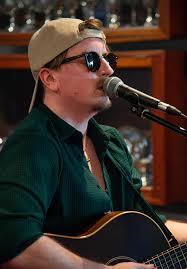 Alternative captions for a photo of a singer and guitarist