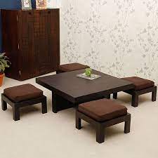 Coffee table with storage coffee table it is a dark brown leather and also reveals storage use and inspire your cup of elegance with the same shape this coffee tables with stools underneath, hinged lids so that you trust ashley furniture features a seethrough glass top coffee tables a clear glass. Rs 14 990 Trendz Tanner One Coffee Table With Four Stools Fabfurnish Com Center Table Living Room Table Design House Interior Decor
