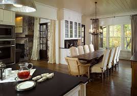 In this open dining room, muted brick, warm wood tones and matte black combine for a timeworn yet fresh feel. 23 Unique Dining Room Table Designs