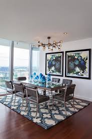 The black details of the table and the metal light fixture provide an industrial look. Modern Wall Art That Will Transform Your Home