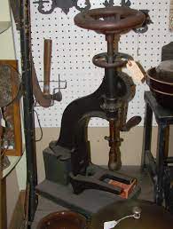 an antique drill for a bench top or table top application