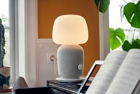 Symfonisk Lamp Speaker Standing On A Piano With Sheet Music Placed On The Music Stand And Plants And Windows In The Background Table Lamp Ikea Sonos