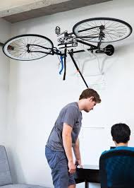 Perfect for storing our bikes. A Hydraulic Lift To Store Your Bike Over Head In Your Apartment Home Or Garage Bike Storage Garage Bike Storage Bike Rack Garage