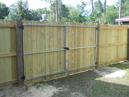 The Inside Of A Stockade Wood Privacy Fence And Double Gate Wood Privacy Fence Wood Fence Design Fence Gate Design
