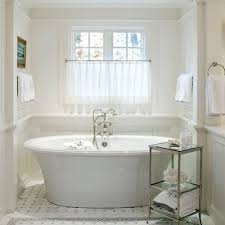 The bathroom are tiled with hex marble tile on the floor and herringbone marble tiles in the shower. Window Treatments Over Tub Design Ideas Pictures Remodel And Decor Bathroom Window Treatments Cottage Bathroom Traditional Bathroom
