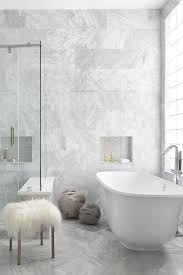 Marble Clad Master Bathroom Features Floor To Ceiling Marble Walls Accented With Gray Glass Hexagon B Master Bathroom Decor Stand Alone Tub Beautiful Bathrooms