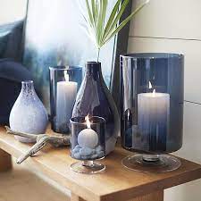 Hurricane candle holders get their name from their ability to shield a candle flame from all but the stiffest passing breeze. London Blue Hurricane Candle Holders Crate And Barrel Table Centerpiece Decorations Table Centerpieces For Home Classic Home Decor