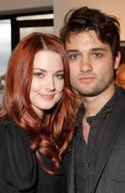 This groom was once a bass guitarist for a band named Paradise in Exile...  which fits his honeymoon situation.