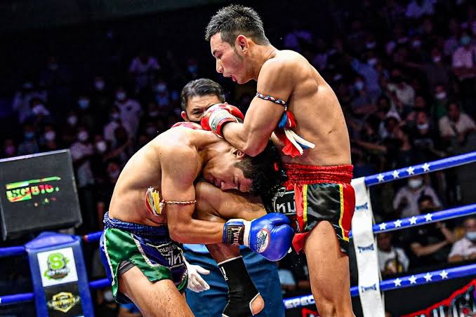 Traditional stadium Muay Thai fight in Thailand with full-size gloves