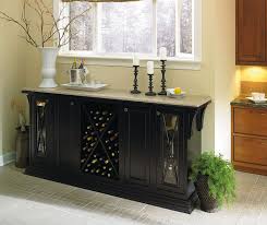 The dining room is located beside a kitchen fitted with a fawn gray island topped with a white quartz countertop and positioned in front white shaker cabinets accented with a white quartz countertop finished with a sink and polished nickel gooseneck faucet fixed beneath a window. Black Storage Cabinet In Dining Room Omega