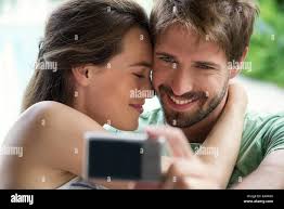 We those couples that love selfies. a young couple taking a selfie outside  Stock Photo