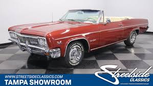 Finished in a stunning color combination of red exterior with fresh black convertible top and a color coordinated black interior. 1966 Chevrolet Impala Classic Cars For Sale Streetside Classics