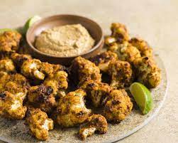 Spicy Roasted Cauliflower With Sun Dried Tomatoes And Almonds Recipe In 2021 Spicy Roasted Cauliflower Spicy Roasted Cauliflower