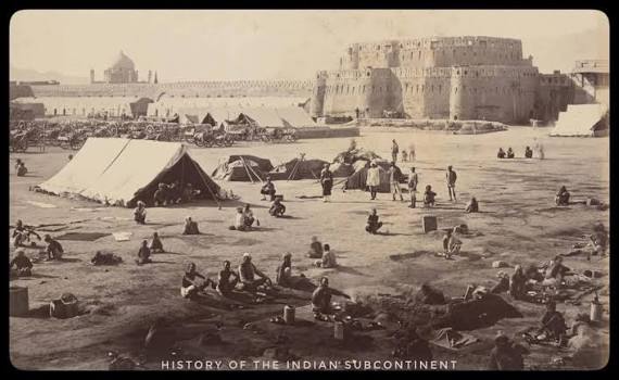 Forces from British India camping at Kandahar: Outside the Kandahar Citadel (locally called "Arg"). The men sitting and standing are mostly camp followers of the British forces from then British India (now