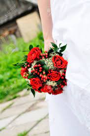 No bouquet is complete without beautiful. Bride Holding Beautiful Red Wedding Flowers Bouquet Stock Photo Picture And Royalty Free Image Image 10255567