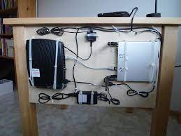 decluttering wires a peg board behind the table excellent source http www reddit com r decl home organization hacks diy organization organization hacks