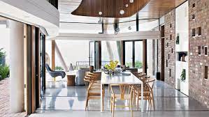 This beach house dining room stays connected through the use of natural wood and leveled shades of blue. Beach House Ideas Home Decor Ideas