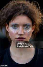 Eleanor Pendleton wearing an off shoulder oversized blue top from... News  Photo