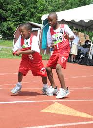 Track and field racers drop baton during handoff. D C Special Olympics Relay Race Baton Handoff